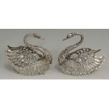 A pair of unusual swan form salt cellars with silver heads, necks and wings,