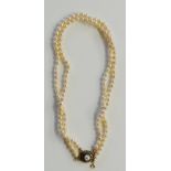 A double row of pearls with safety chain