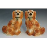 A pair of pottery spaniels, painted detailing,