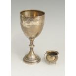 A silver goblet of conventional form, th