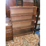 An open Oak floor-standing Bookcase having plain top and sides with four shelves and plinth base,