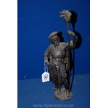A Spelter Figure of a Soldier carrying a flaming torch,