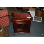 A Piano Stool with pull down front and padded seat