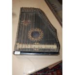 An ebonised and painted Anglo American Zither,