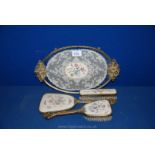 A four piece Dressing Table Set including Tray, Two Brushes and Mirror decorated with lace,