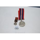 A WWII Defence Medal and a small 1901 Orange Free State Medal.