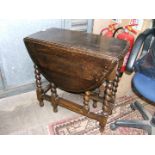 A 1940's Oak oval top drop-leaf gateleg Dining Table having bull-nose moulded top,