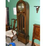 A deco Oak cased Longcase Clock having dome topped case with single long door with two panels,