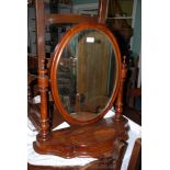 A good Victorian Toilet Mirror having oval mirror in moulded frame, in finial top turned supports,