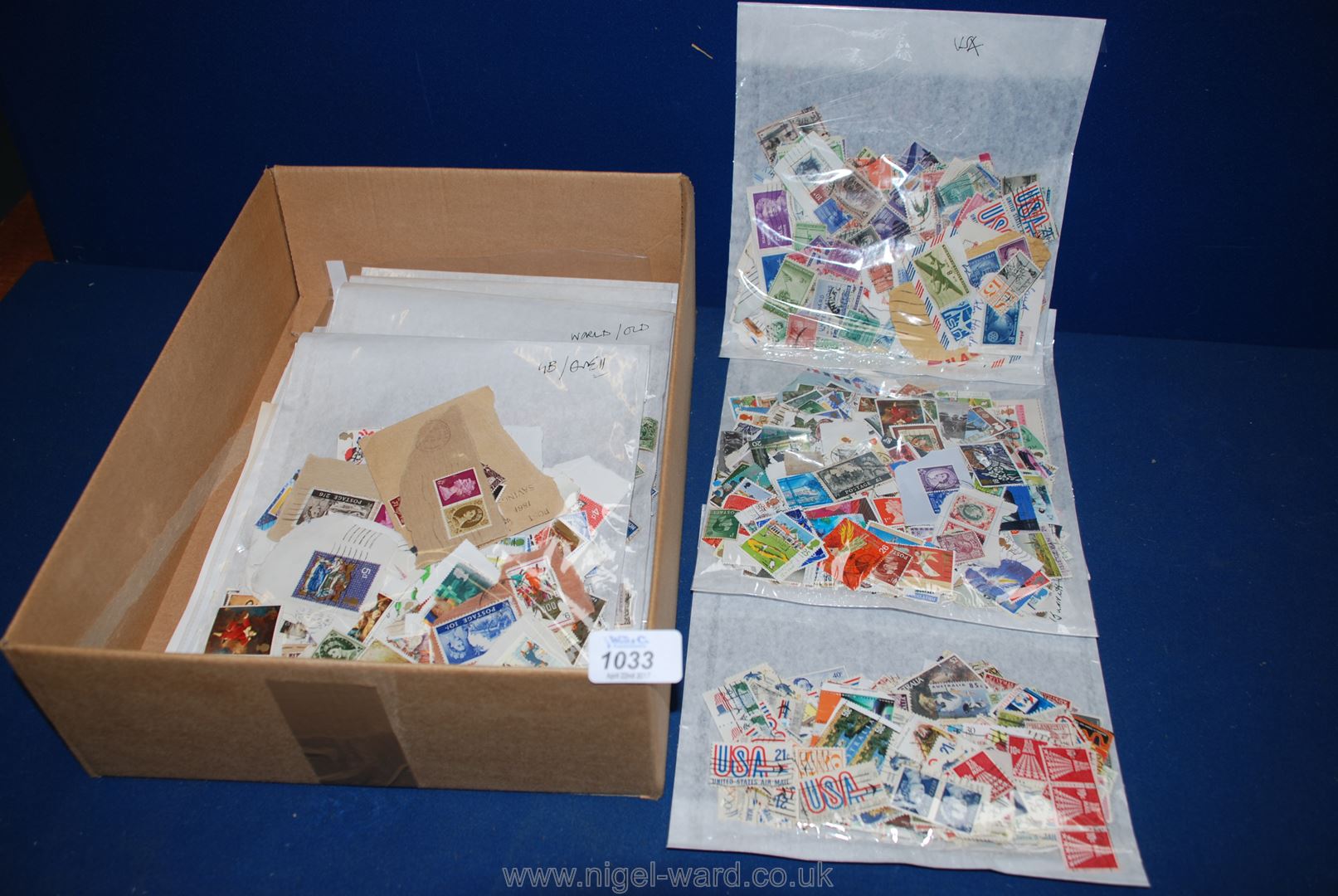 A box of loose stamps in bags.