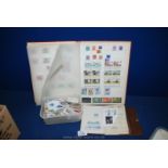 A Stamp Album with loose stamps along with a small brown album with loose stamps and a small box of