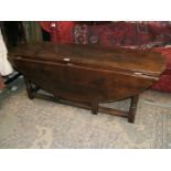 A reproduction Oak 'wake' style drop-leaf Coffee/Lounge Table having plain edge top and leaves,