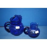 Two blue glass Jugs