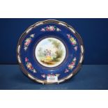 A Copeland Spode plate with scalloped edge in navy with floral decoration and detail of a couple