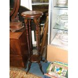 A reproduction Regency style Mahogany two tier Pot Stand having circular moulded edge top,