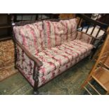 A circa 1900 Oak show frame bergere three seater Settee having finial topped back supports with