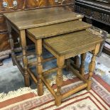 A reproduction medium Oak nest of three Occasional Tables with turned legs and stretchers