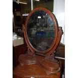 An elegant Victorian Mahogany Toilet Mirror having oval mirror in ornate curved and moulded scroll