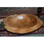 A large Wooden Bowl carved from a single piece of wood