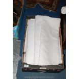 A box of linen and cotton sheets