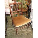 An Arts and Crafts Beech nursing Chair with shaped top rail on delicate turned supports,