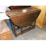 A Georgian Oak oval top gateleg drop-leaf DIning Table having single plank top and two plank leaves,