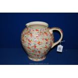 A Kensington Ware Art Deco Milk Jug with multi-floral decoration - 8" high - handle a/f.