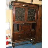 An interesting 1920's Oak Bureau Bookcase having pair of opposing 15 pane glazed doors with leaded