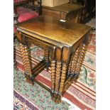 A reproduction Nest of three Oak Tables on bobbin turned legs with stretchers