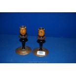 A small pair of Candlesticks with beaten copper bases and possibly tortoiseshell detail to the