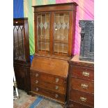 A good arts and crafts Bureau Bookcase, having moulded cornice over pair of opposing leaded,