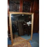 A large gilt framed rectangular Wall Mirror with stylised acanthus moulded gesso detail with inner