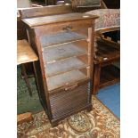 A 1930's Oak Tambour fronted Office Cabinet having upstand back, moulded edge square top,