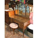 A reproduction Queen Anne style Walnut kneehole Dressing Table having triple mirrors,