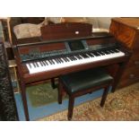 A modern Yamaha Clavinova, in wood finish case, and having USB port, drum section, style control,