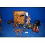 A quantity of wooden animals including camels, a wooden elephant, three pairs of small wooden clogs,