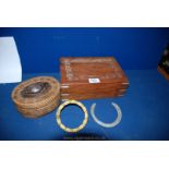 A carved wooden jewellery box, a raffia box and a horseshoe,