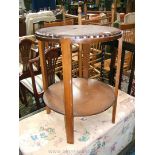A 1940's Oak two tier Stand, moulded edge top on four rectangular legs with circular lower tier,