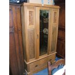 An Edwardian satinwood and Walnut single door Wardrobe having central rectangular bevel plate