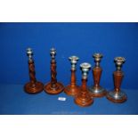 Three pairs of Treen Candlesticks including barley twist and conical shapes
