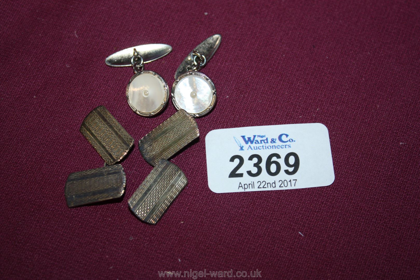 A pair of Silver Cufflinks and a mother of pearl pair of cufflinks