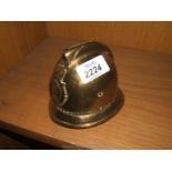 A Brass Money Box in the form of a Policeman's Helmet