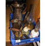 A quantity of copper and brass items including two jugs, blow lamp, bell, oil lamp,