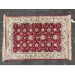 A red ground and ivory Rug, 45'' x 67''.