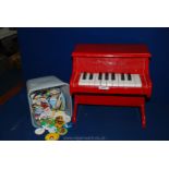 A "New Classic Toys" Piano and a box of miscellaneous badges