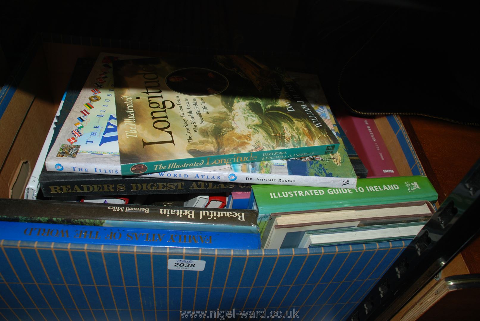 A box of books inc Atlases, Guide to Ireland, Book on Longitude,