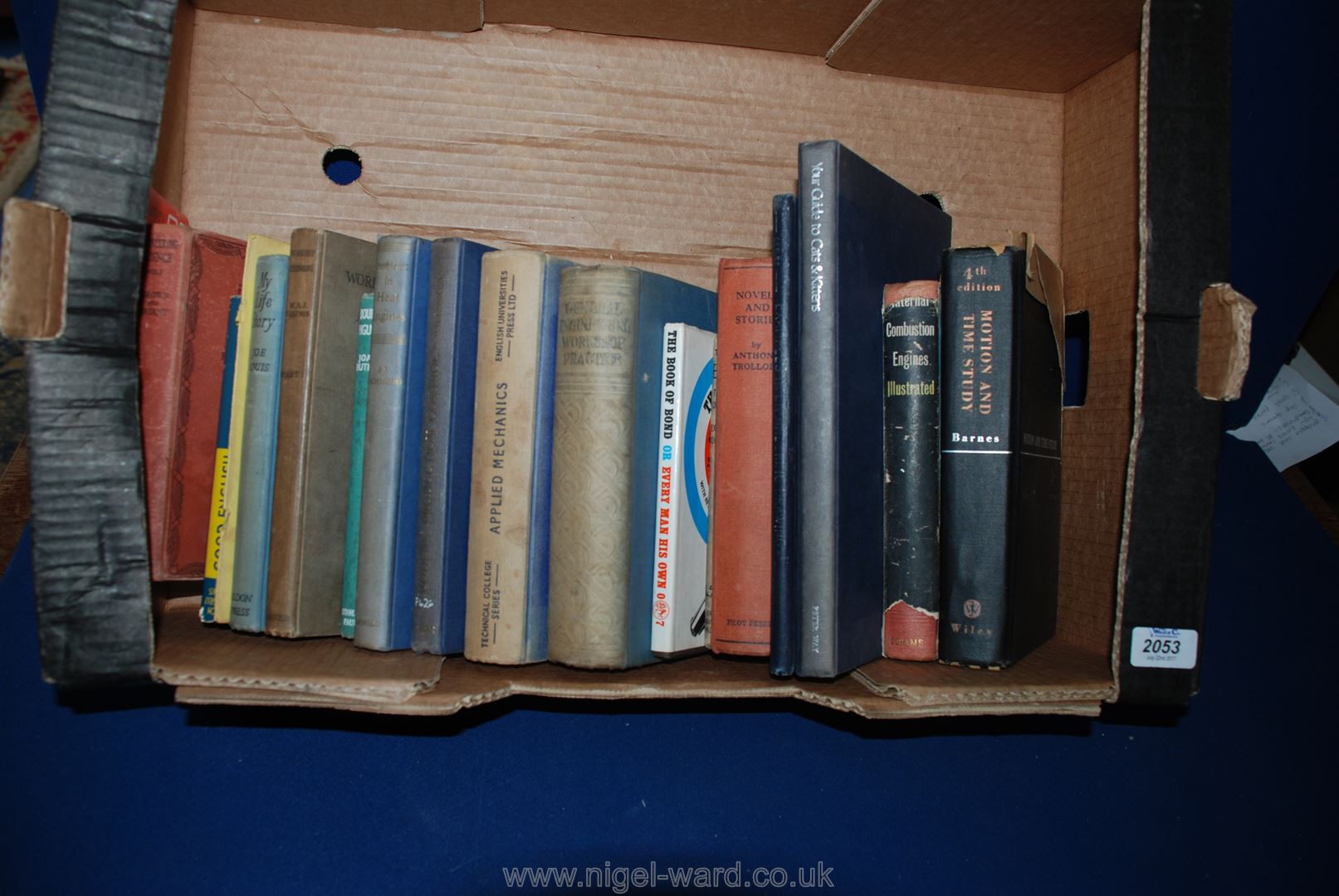 A box of books 'Applied Mechanics', 'The Book of Bond' etc.