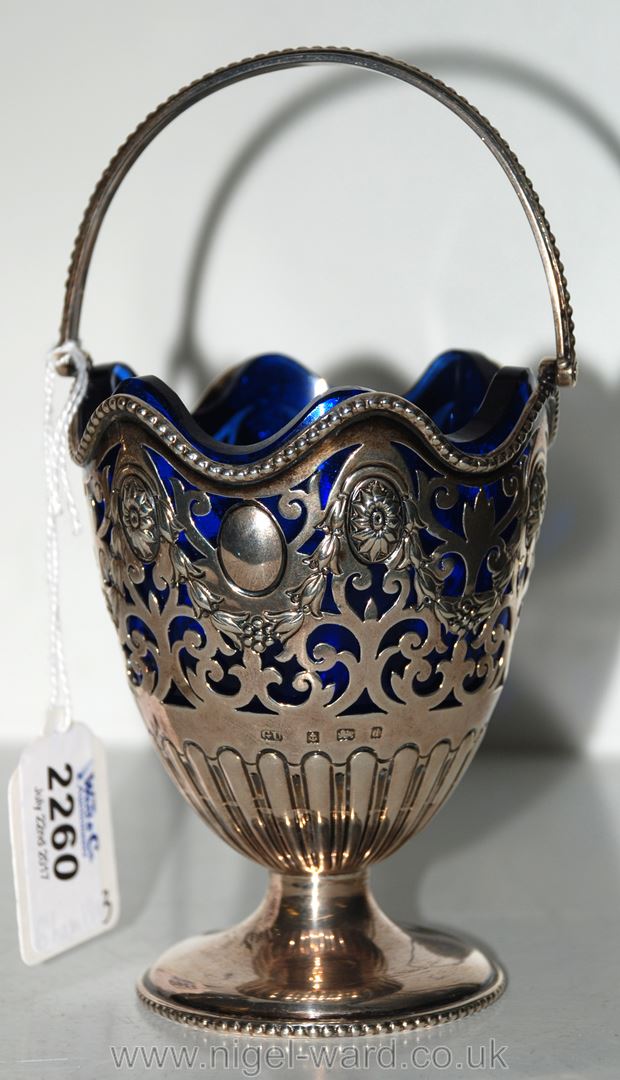 A pierced Silver Sugar Basket with blue liner,