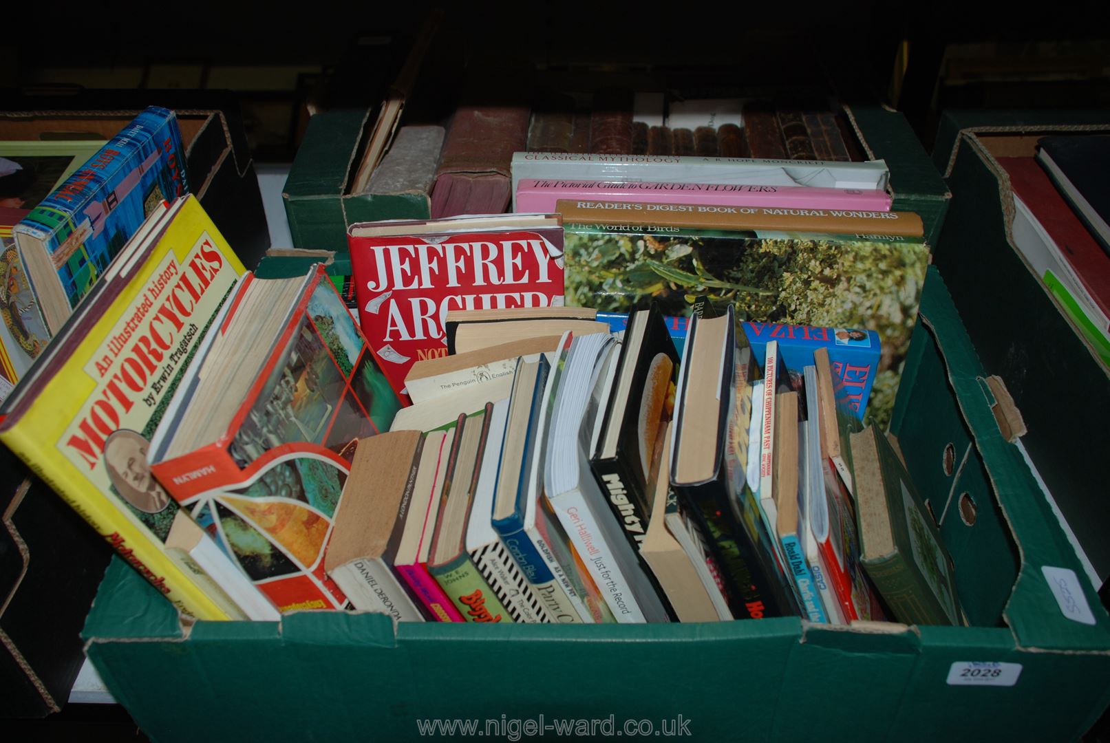 A box of books inc novels, trees, motorcycles, natural wonders,