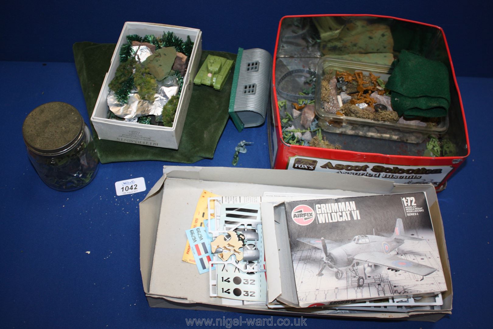 A box of Airfix including tanks, trees, figures, etc.